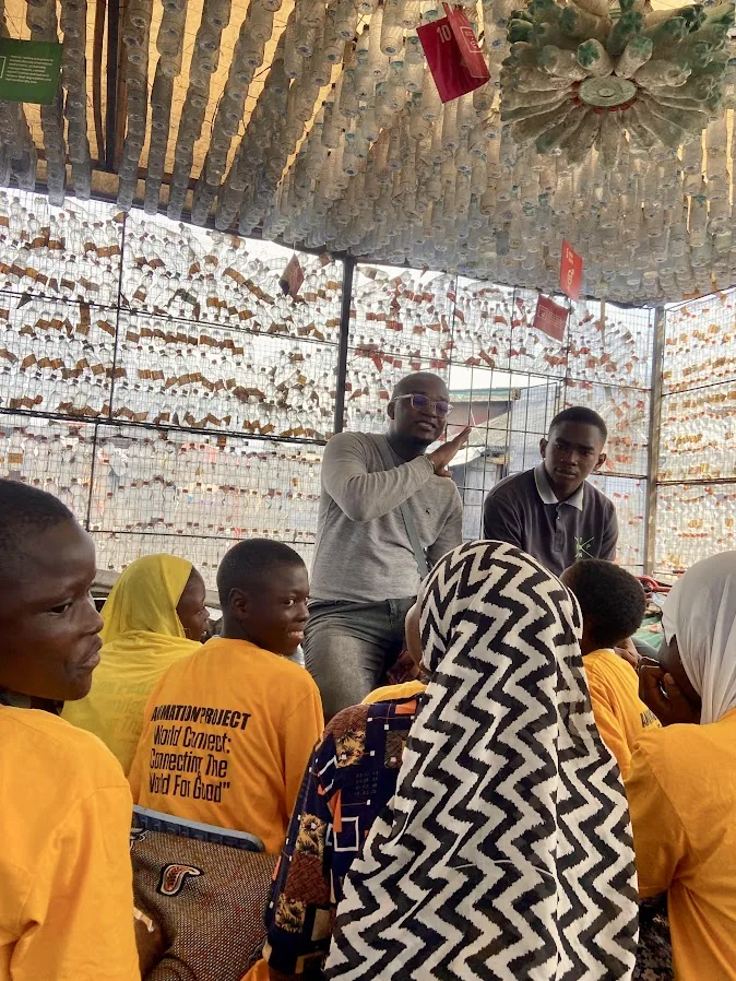 Ademola spending time with children during a community visit
